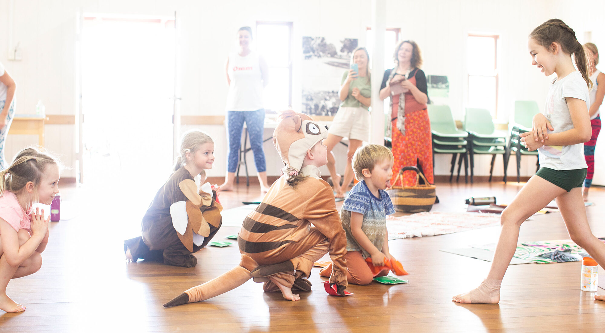 Children doing yoga in a studio.