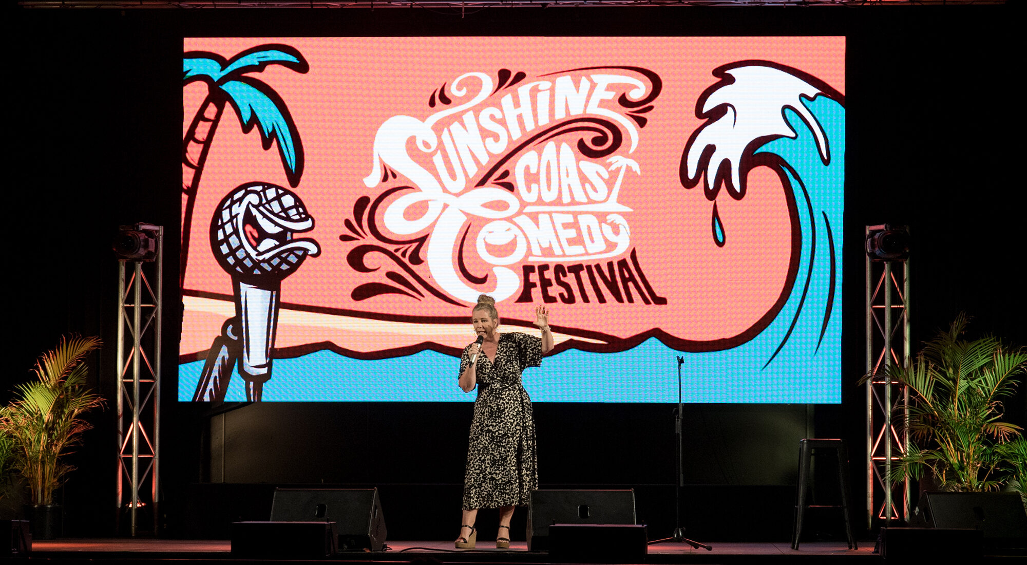 A lady stood on a stage.